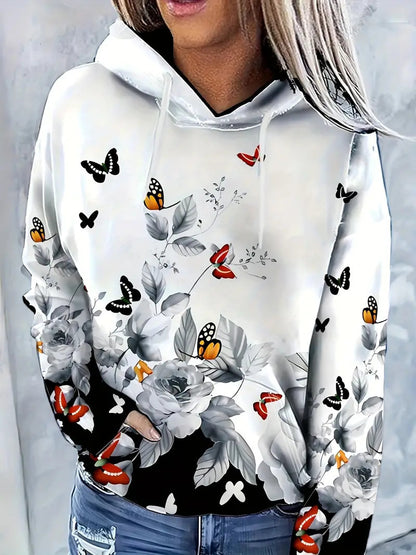 White hoodie with floral and butterfly designs on a gray background