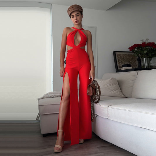 Woman in a red jumpsuit standing in a living room.